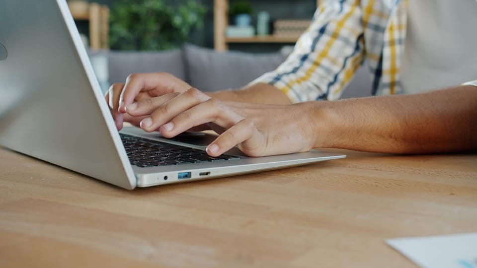 Person typing on a laptop